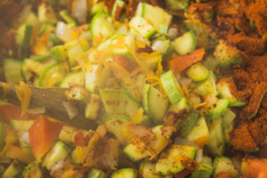 An illustration of Akcee alongside other ingredients being sauteed in a pan to be consumed for its rich mineral content